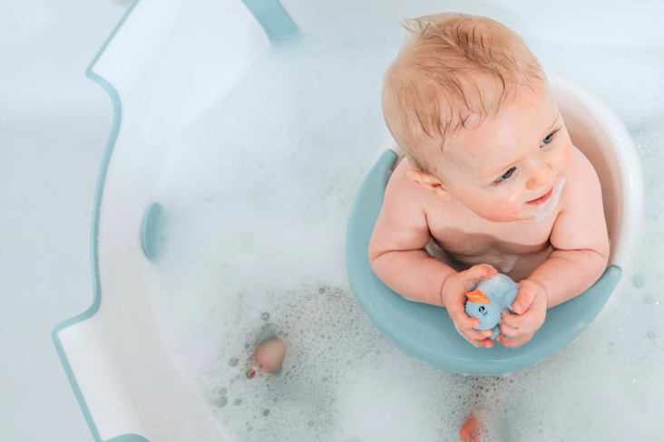 Award winning BabyDam Bathwater Barrier baby in bath blue