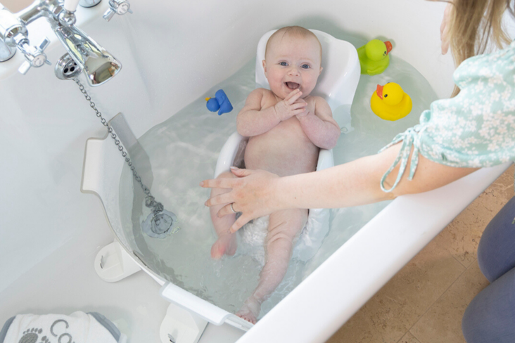 Award winning BabyDam Bathwater Barrier baby in bath grey