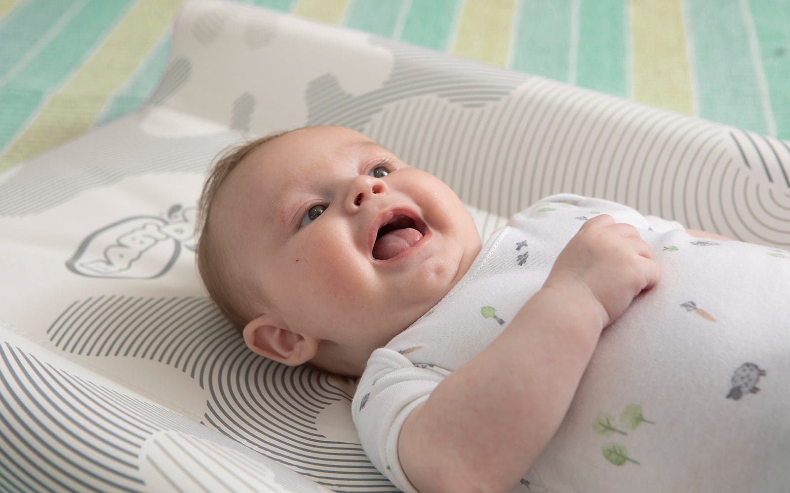baby boy on wedge changing mat